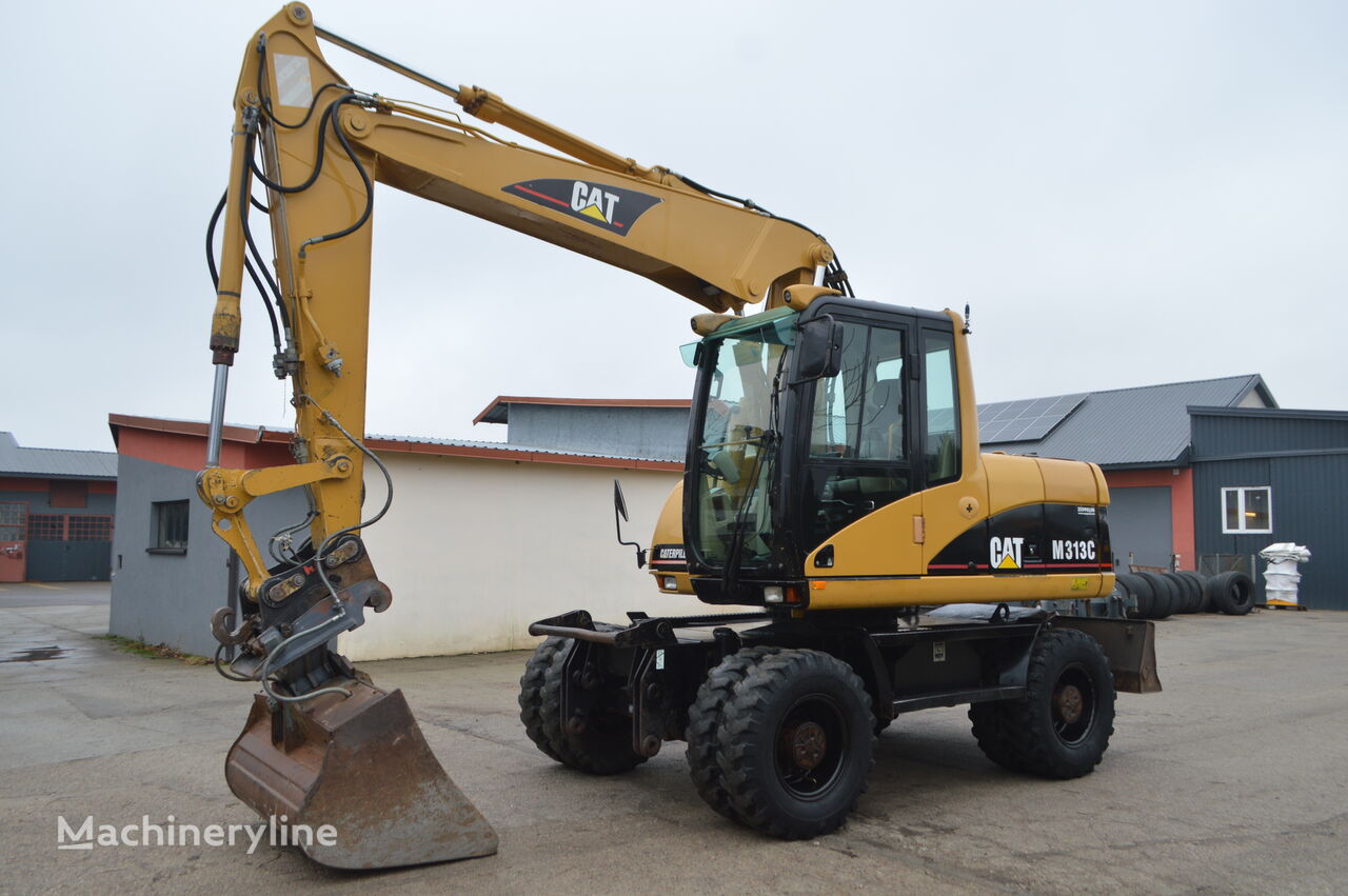 Caterpillar M313C riteņu ekskavators