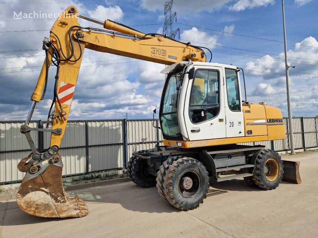 pelle sur pneus Liebherr A 316 Litronic