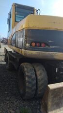 Caterpillar M 318C kaivuri virranjakaja