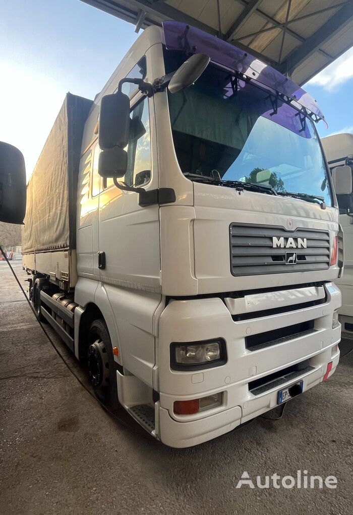 MAN TGX 26.440 tilt truck