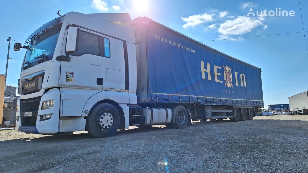 tracteur routier MAN + semi-remorque à rideaux coulissants