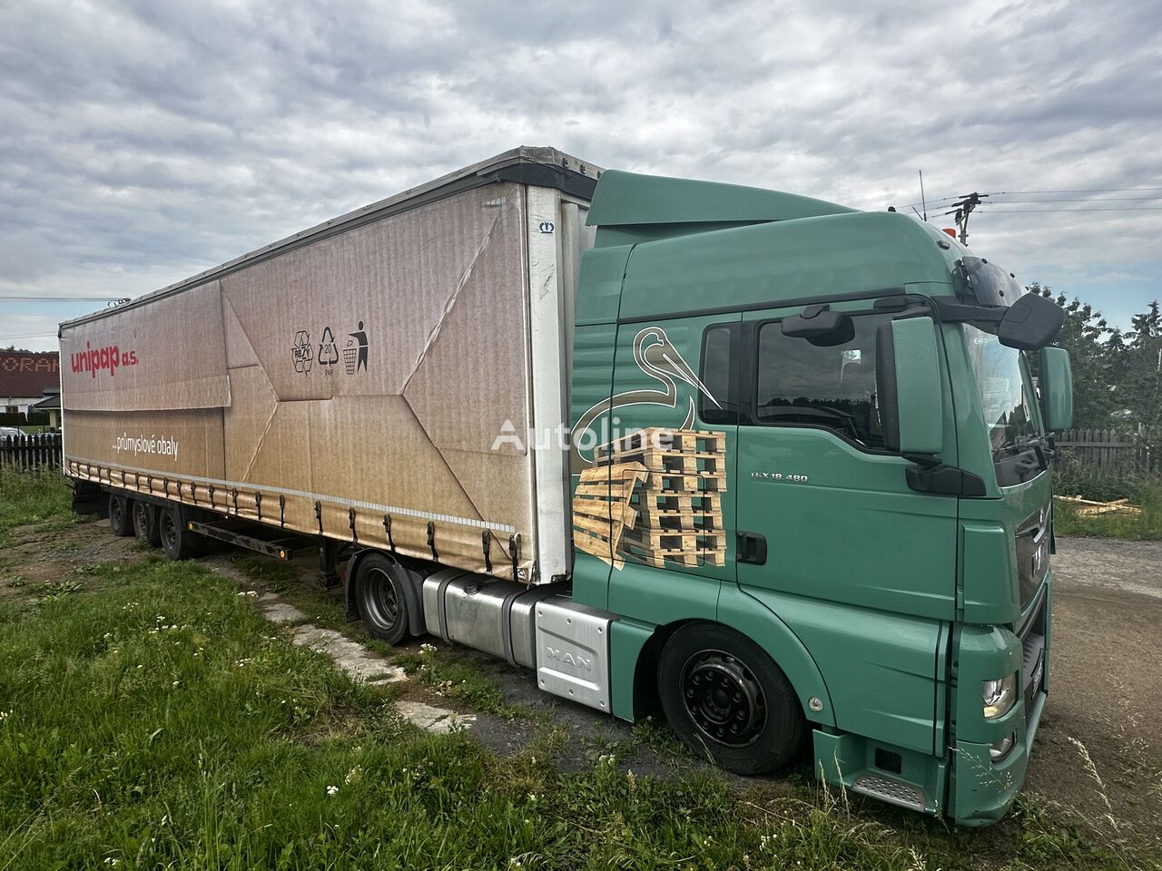 tracteur routier MAN TGX 18.480 + semi-remorque à rideaux coulissants